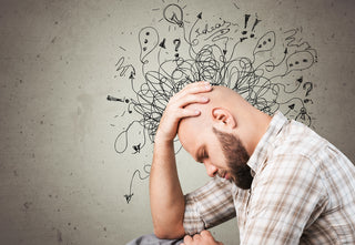 Man holding his head with confusion representing brain fog