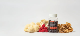 Nummies mushroom gummies bottle surrounded with raspberries and various mushrooms